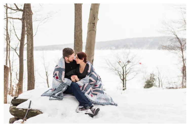 vermont outdoor winter engagement session wrapped in a quilt