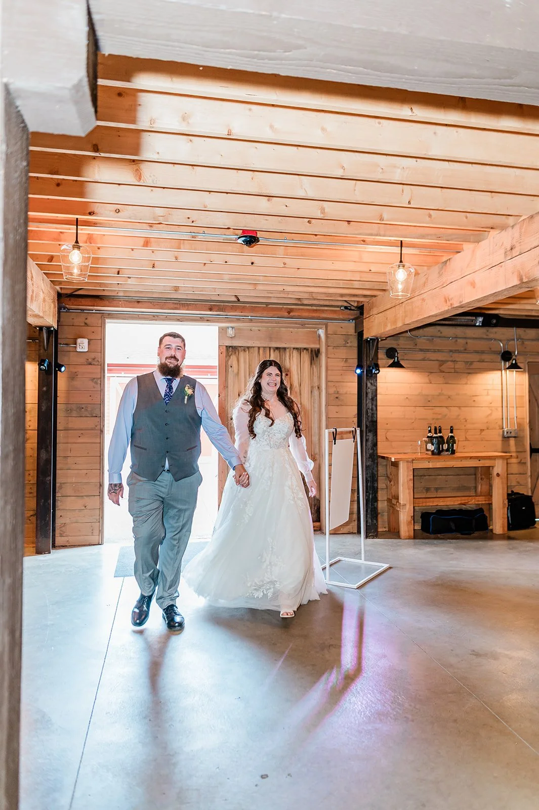 Bride and groom making their grand entrance into the barn reception