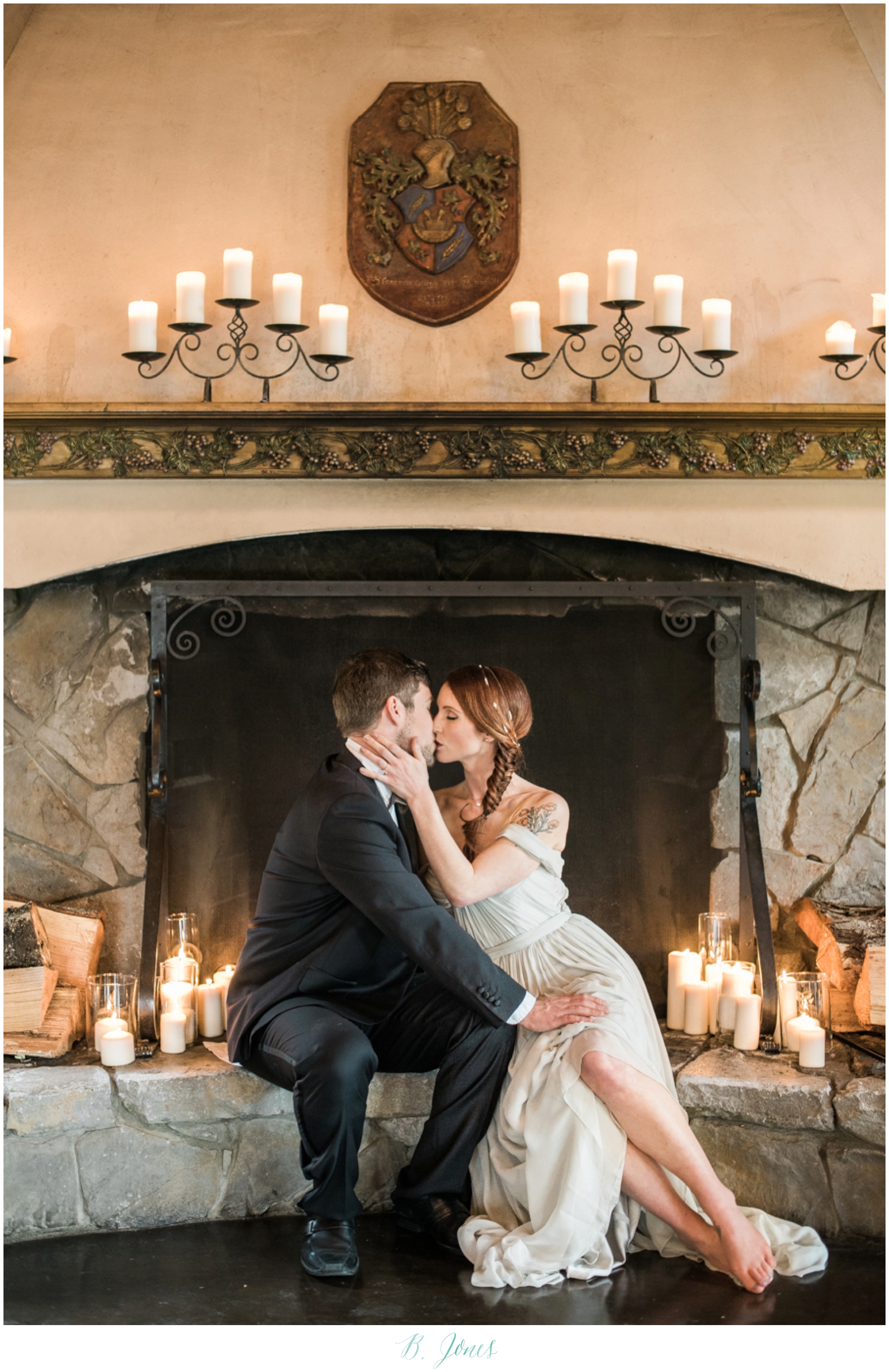 Bride & groom in front of fireplace at Delille cellars