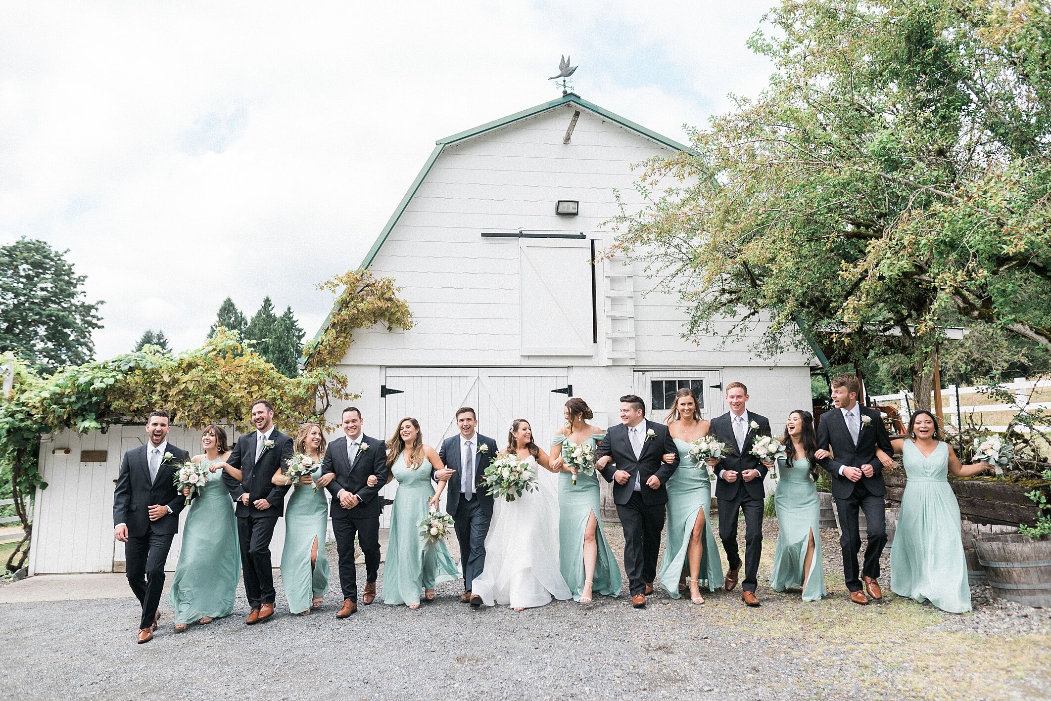 Wedding photo in front of the white barn at Chateau Lill