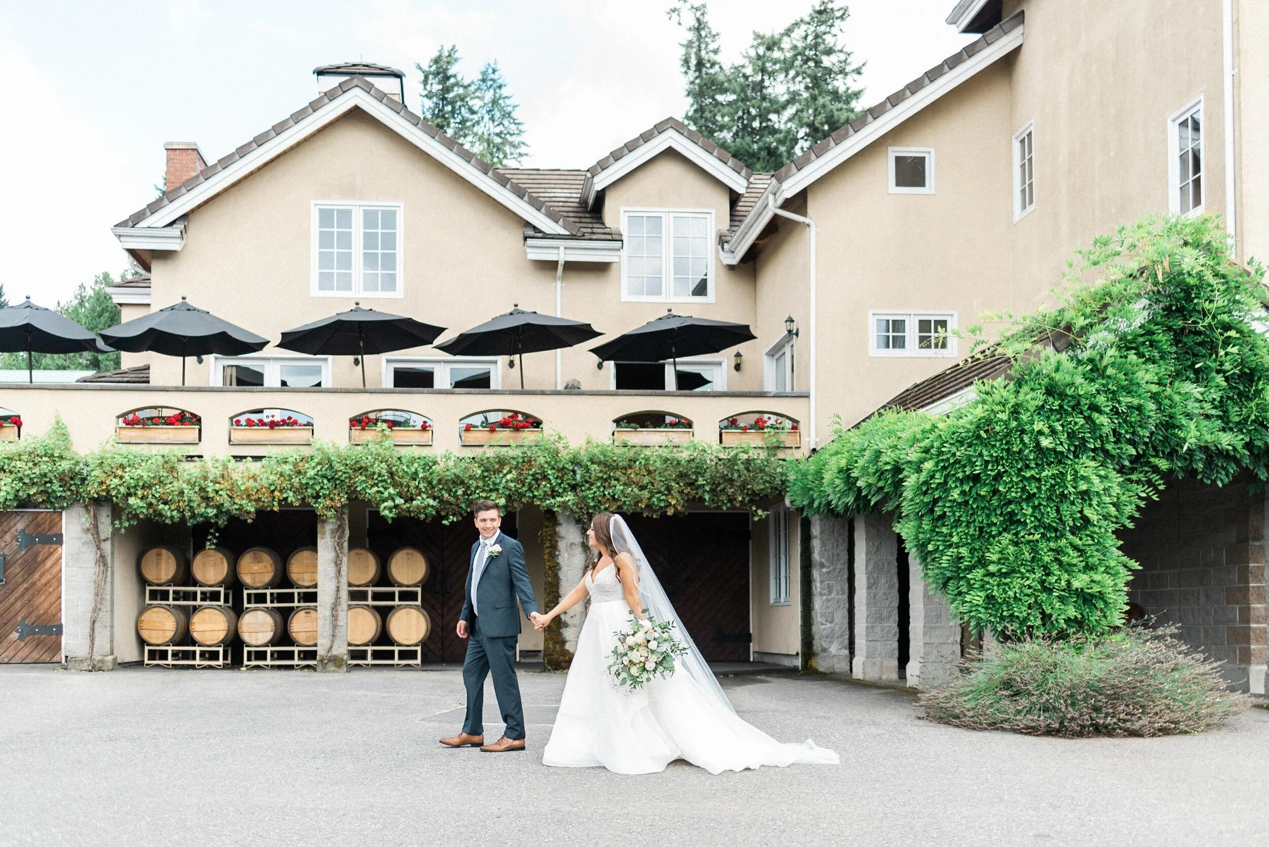 Wide shot of the Chateau Lill estate grounds in Woodinville WA showing the manicured gardens, vineyard, and French architecture