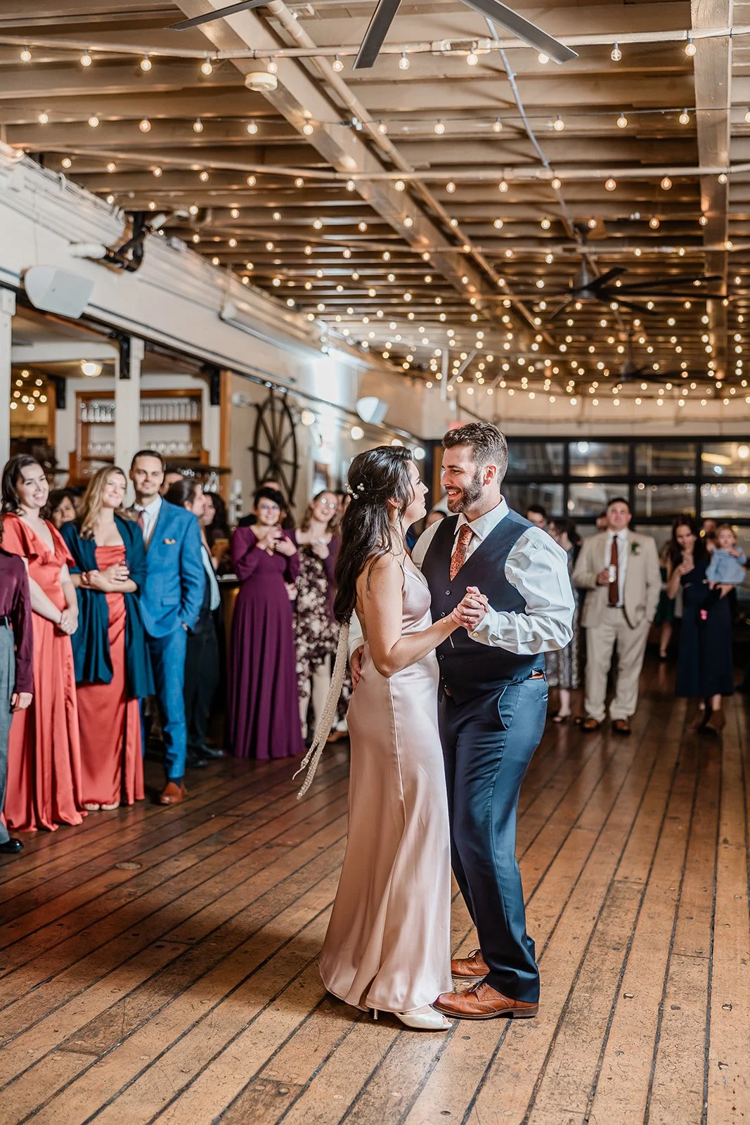 First dance under string lights inside the MV Skansonia