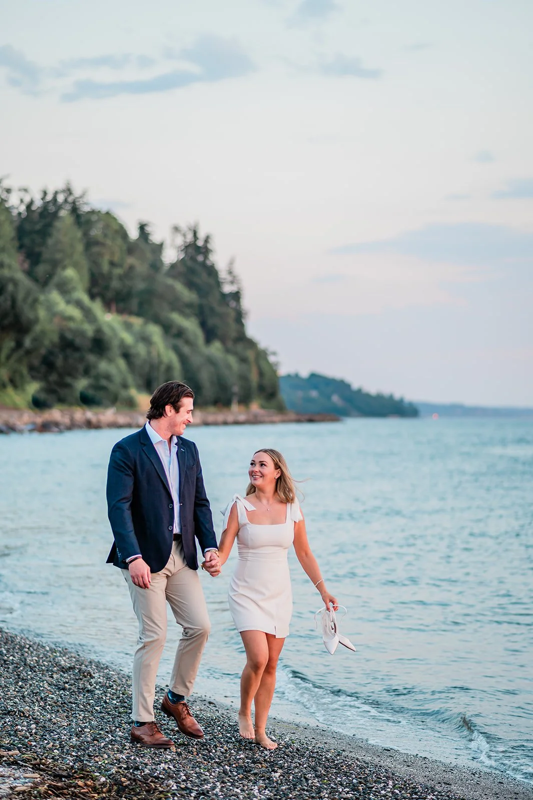 Barefoot couple walking along the beach at Mukilteo Lighthouse Park