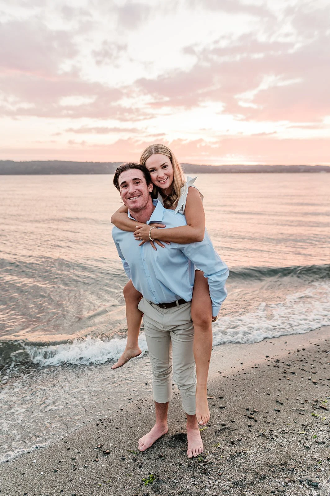 Piggyback ride at sunset on the beach during a waterfront engagement session