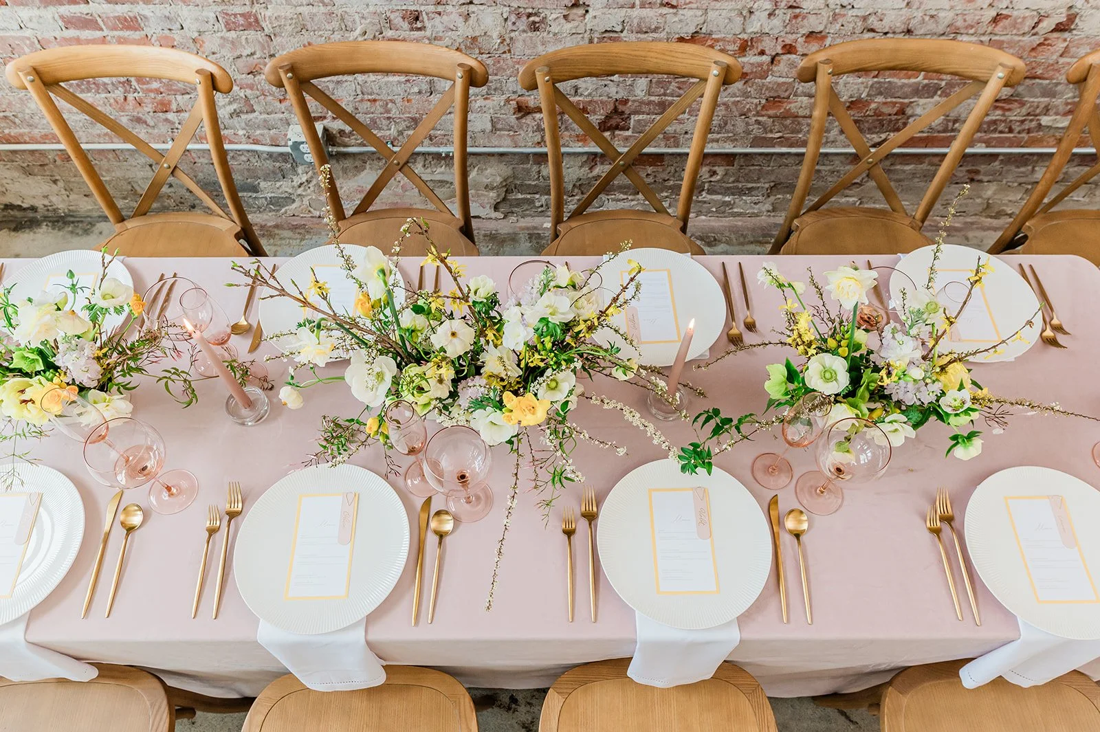 Overhead spring tablescape — gold cutlery, blush linens, garden florals by Goldenrod Floral