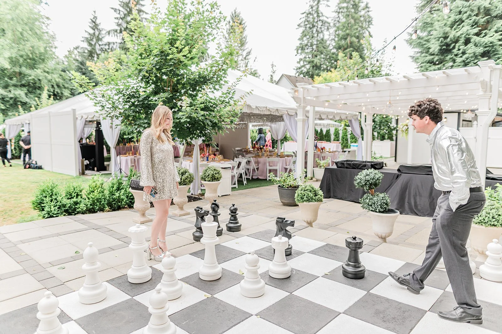 Bride and groom playing giant lawn chess on the Jackson Manor grounds