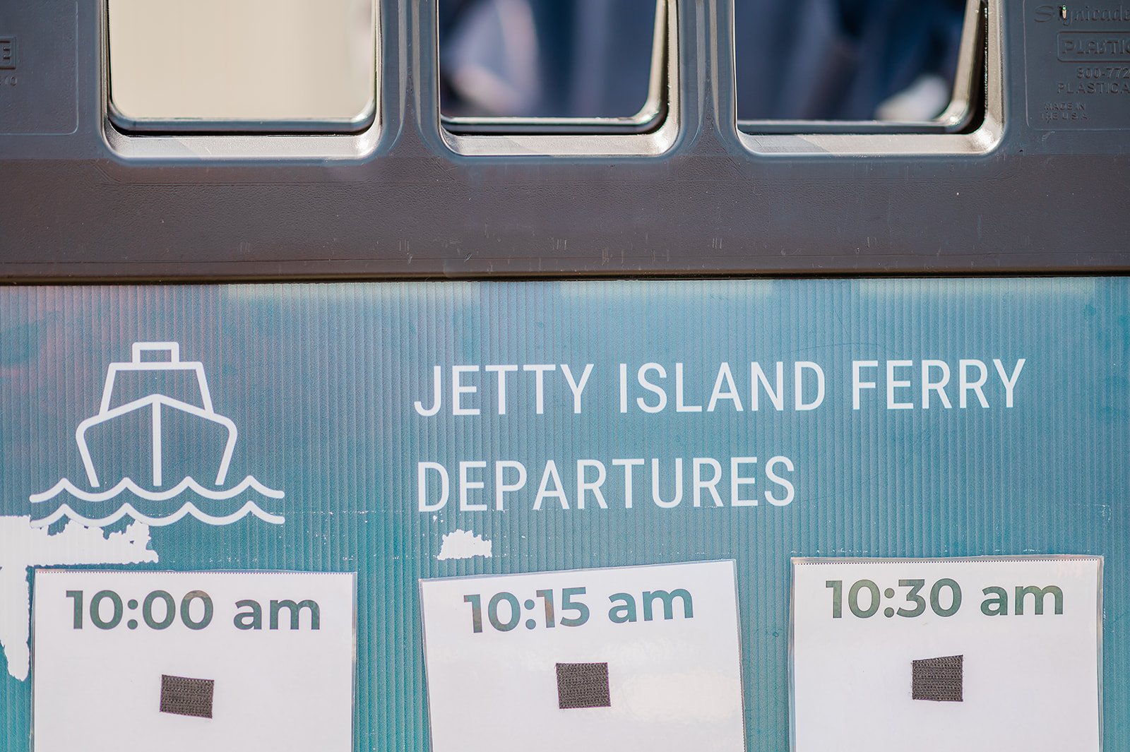 Jetty Island Ferry departure schedule sign at the 10th Street Boat Launch in Everett Washington