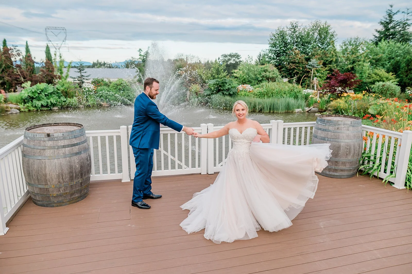 Couple dancing on the deck overlooking the pond fountain at The Carey Gardens wedding venue