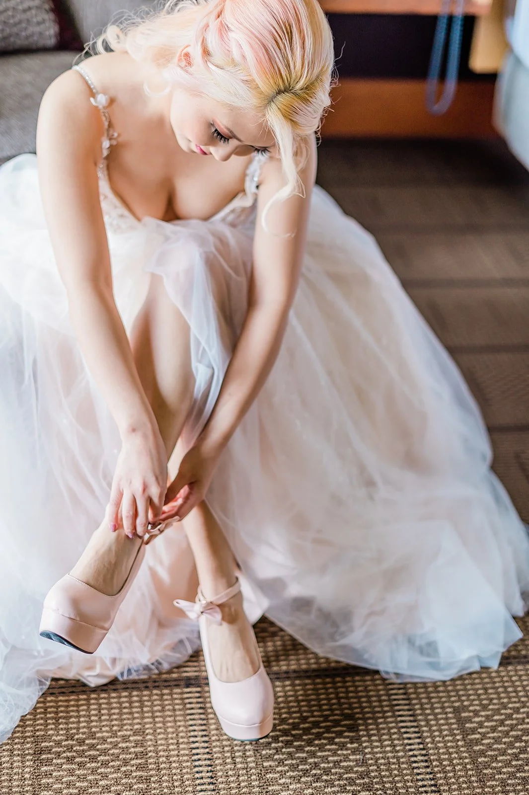 Bride putting on her shoes while getting ready in the Burke Room at Willows Lodge, Woodinville WA
