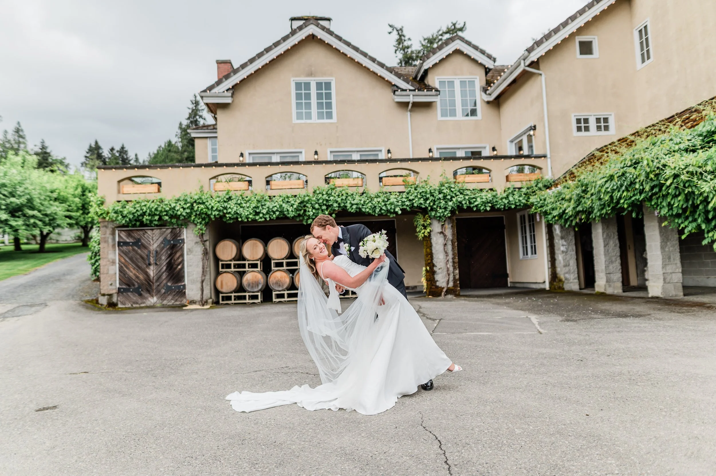 Wedding party portrait in front of the Chateau Lill estate in Woodinville WA, with the entry portico, manicured gardens, and French Renaissance architecture as backdrop