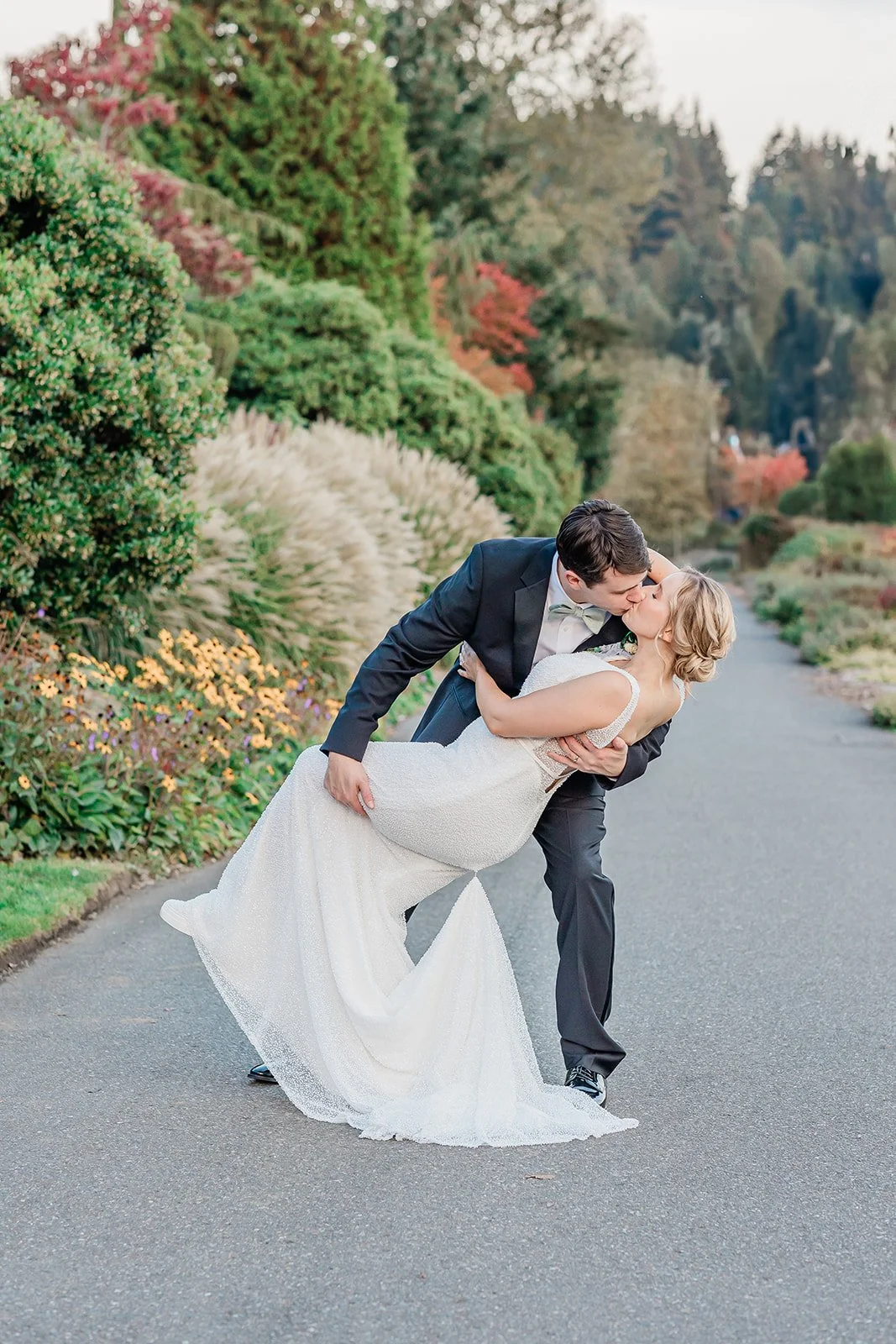 Couple embracing on the sidewalk in front of Willows Lodge in fall, Woodinville WA