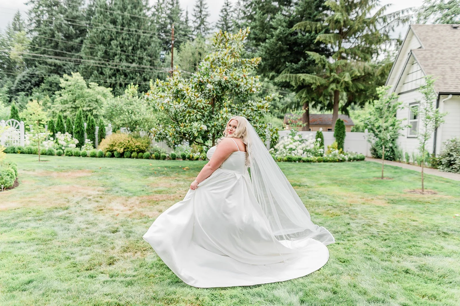 Bride twirling in her gown on the open lawn in front of the Jackson Manor estate