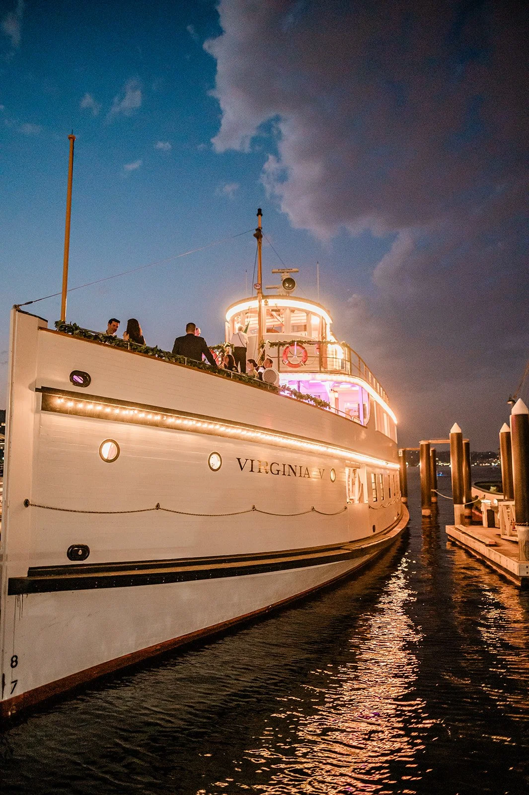 The Virginia V Steamship lit up at night under a moody Seattle sky