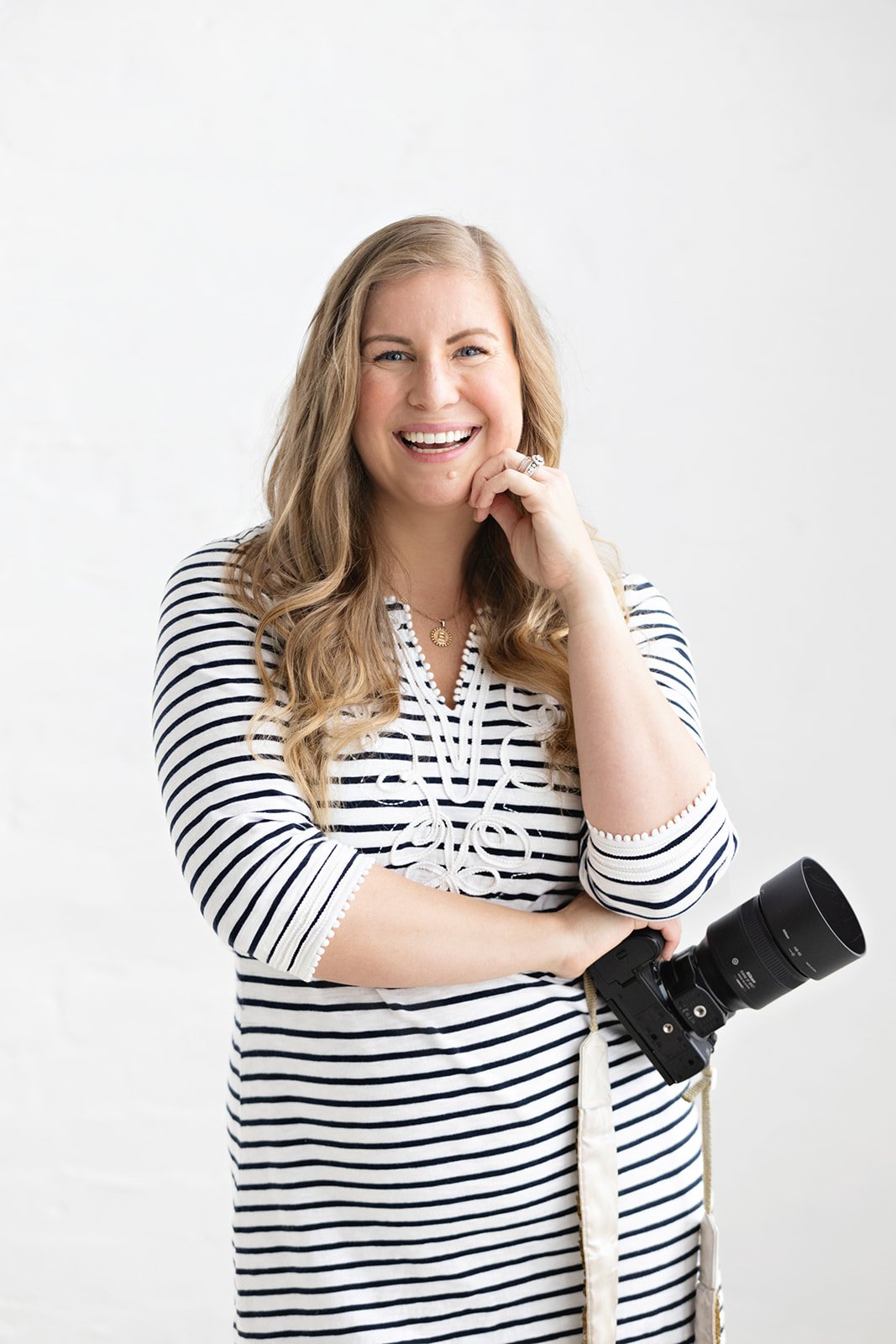 Becca Jones, Seattle boat wedding photographer, holding her camera