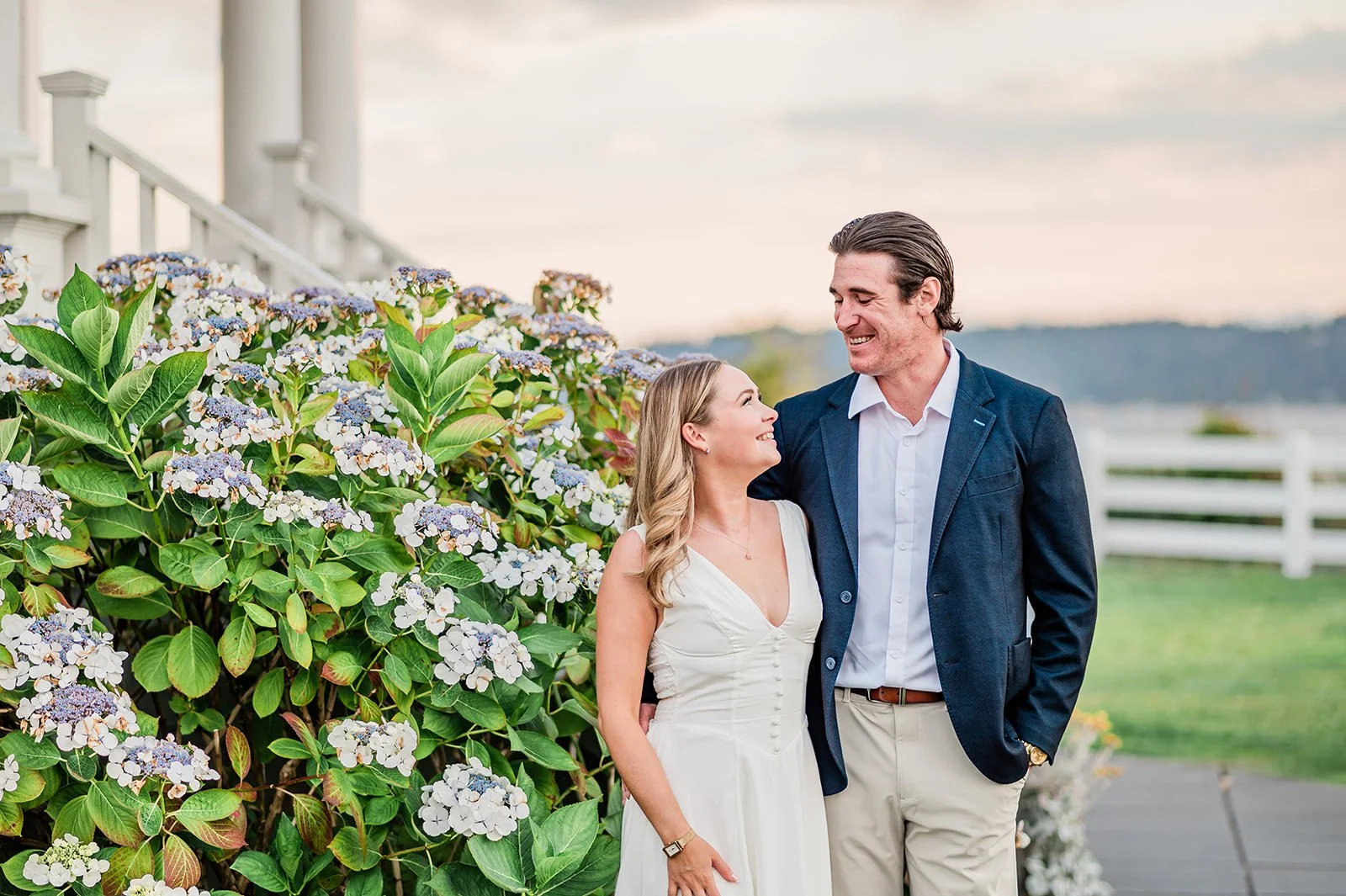 Couple beside blooming hydrangeas at Mukilteo Lighthouse, Nantucket-style engagement photos