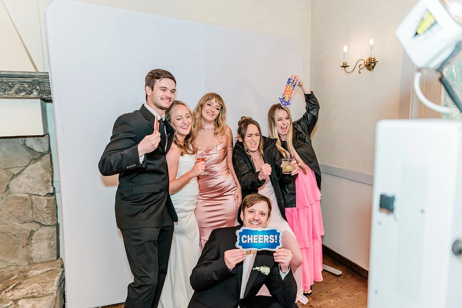 Guests posing with props at the Luxe Photobooth during a Chateau Lill wedding