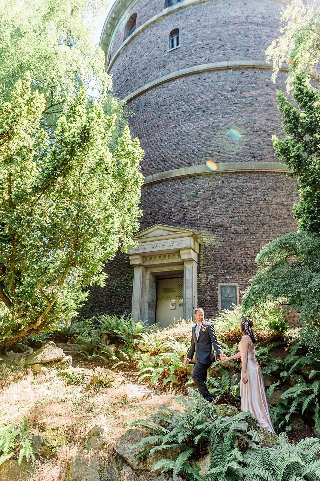 Bride and groom walking the garden trail to the Volunteer Park water tower Seattle