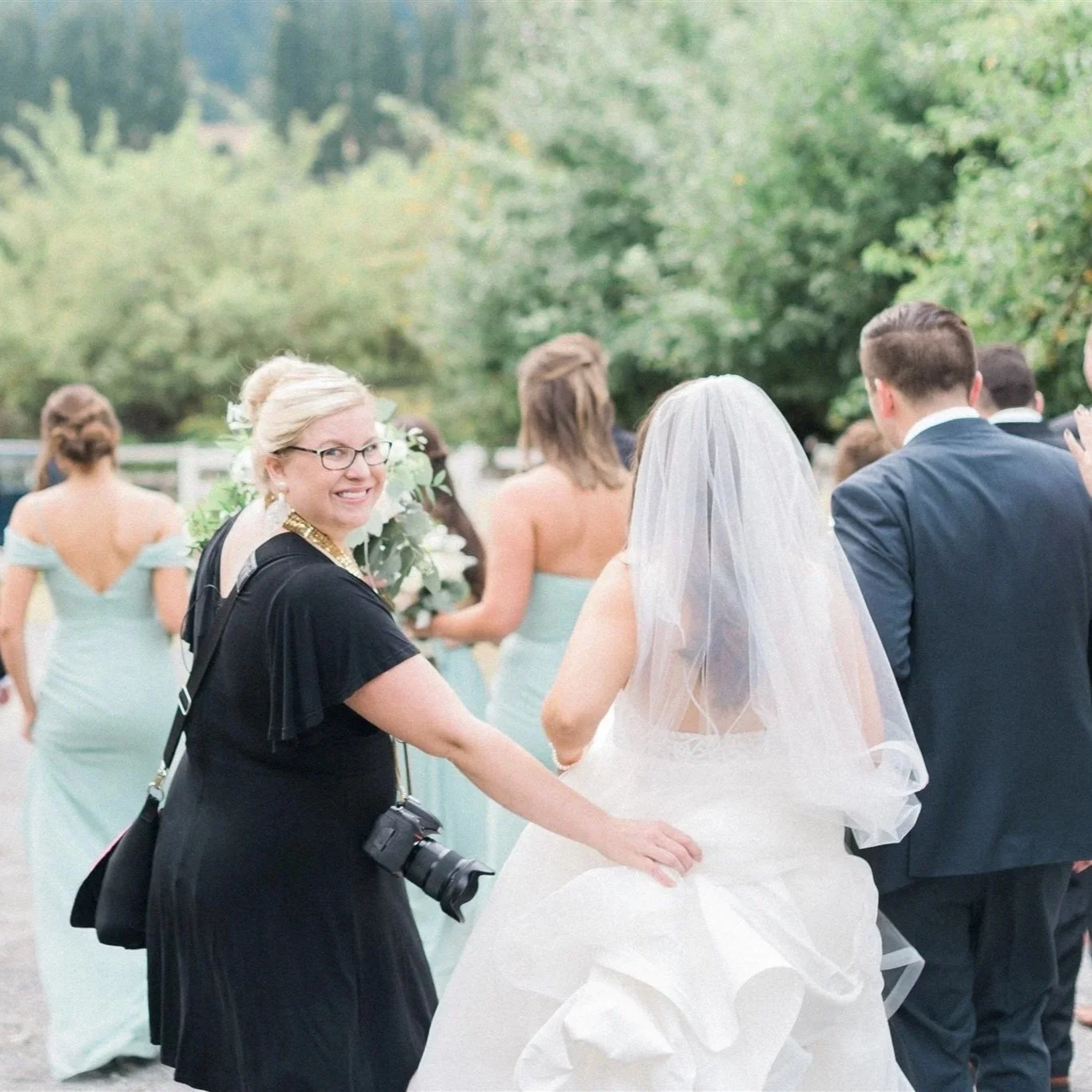 Becca Jones directing a wedding party during portraits behind the scenes