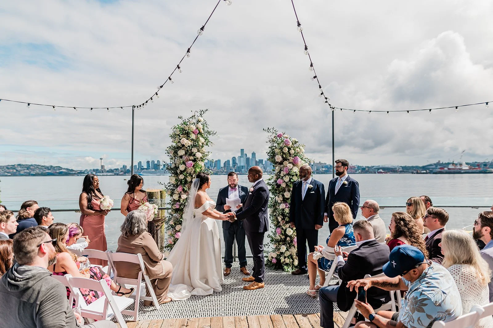 Salty's on Alki wedding ceremony on the waterfront dock with the Seattle skyline