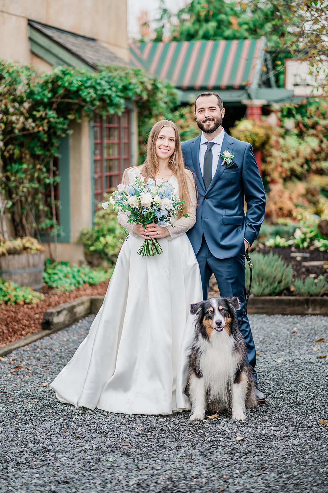 Couple with their dog in front of Barking Frog at Willows Lodge, Woodinville WA