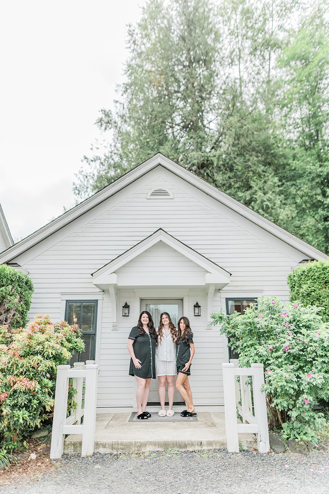 Bride with her mom and sister in matching pajamas on the porch of the Marionfield Farm bridal cottage