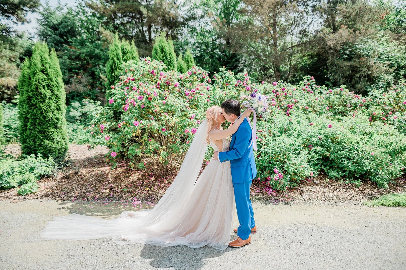 Bride and groom kissing in the rose garden at Willows Lodge, Woodinville WA