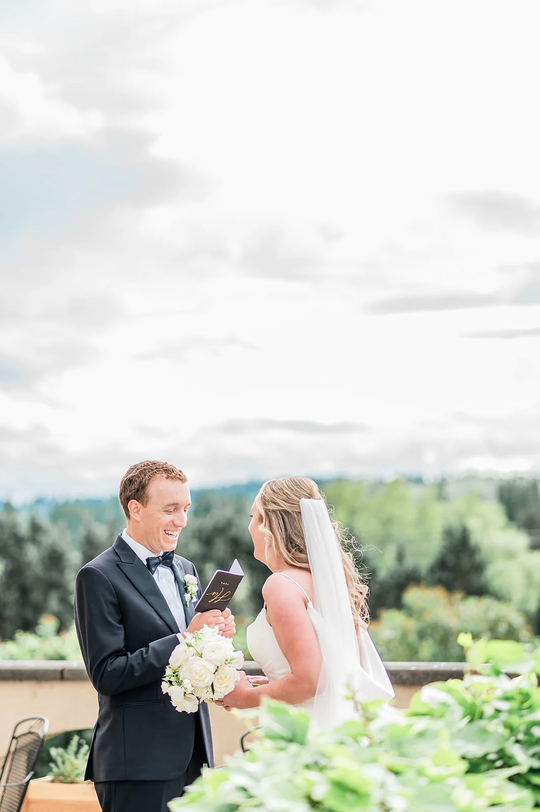 Couple reading private vows on the Chateau Lill balcony overlooking Woodinville wine country