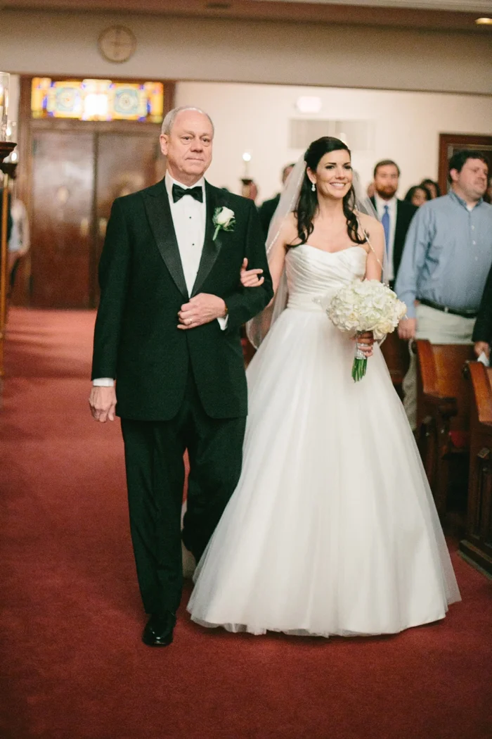 Bride walking down isle in church