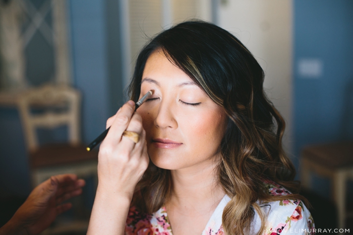 Bride getting makeup done before wedding in Portofino Hotel