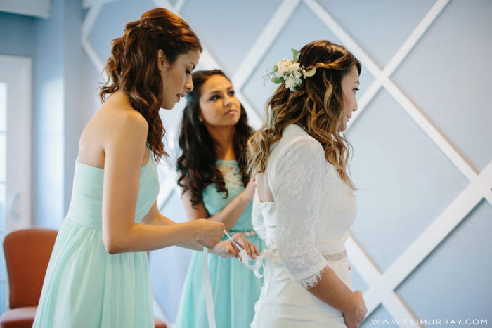 Bride getting into her wedding dress