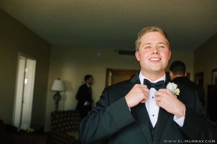 groom putting on bow tie
