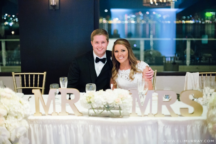 newlyweds at head reception table