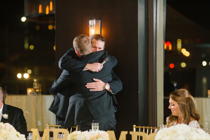 best man and groom hug