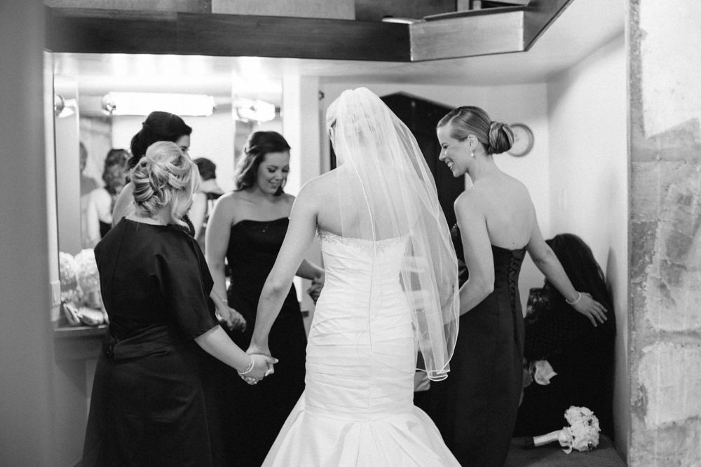 bride and bridesmaids praying together