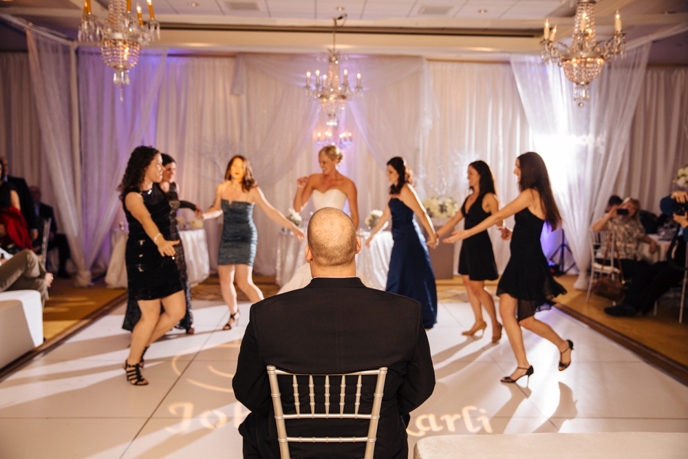 Bridemaids dancing for the groom