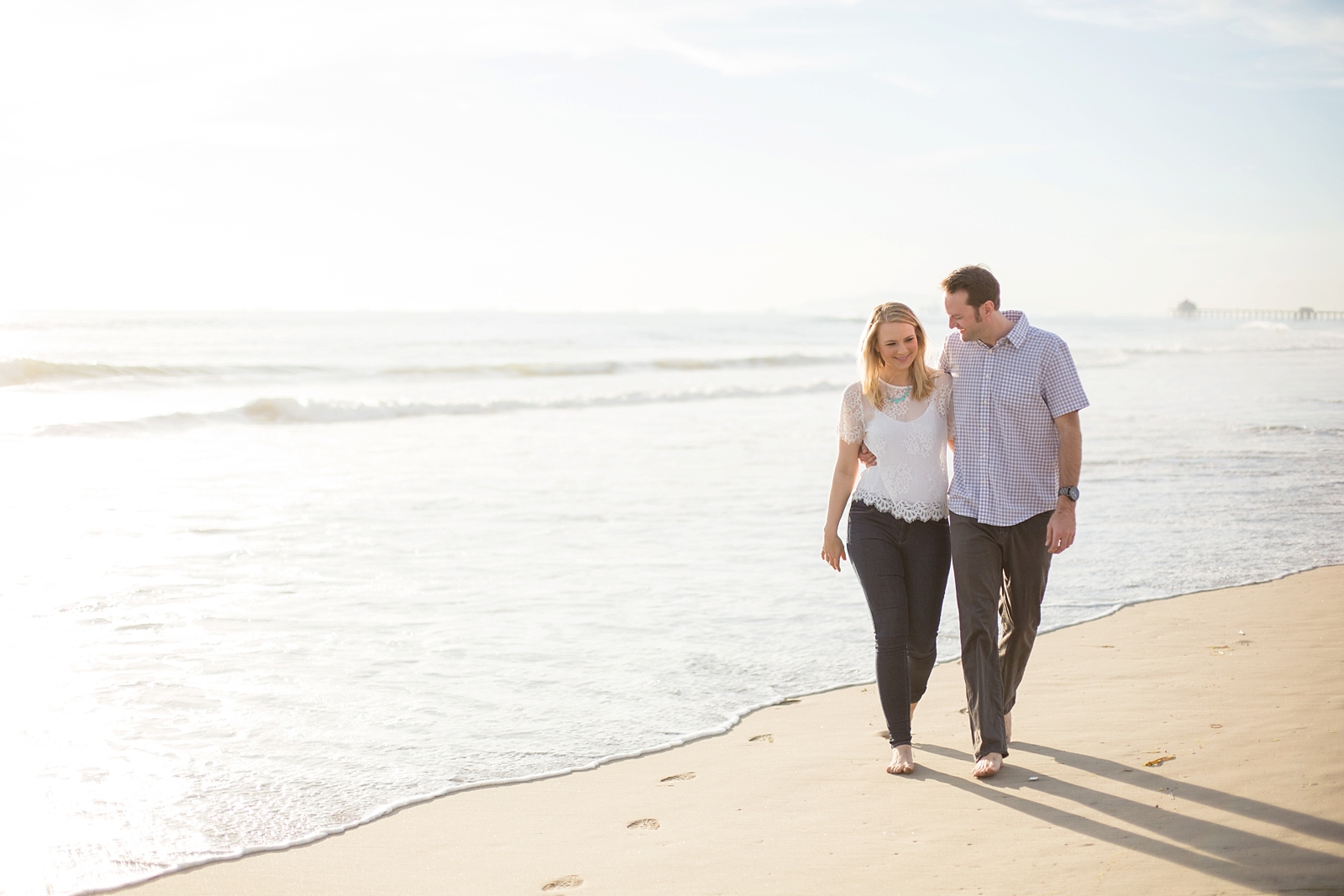 Engaged couple take a walk in Huntington Beach