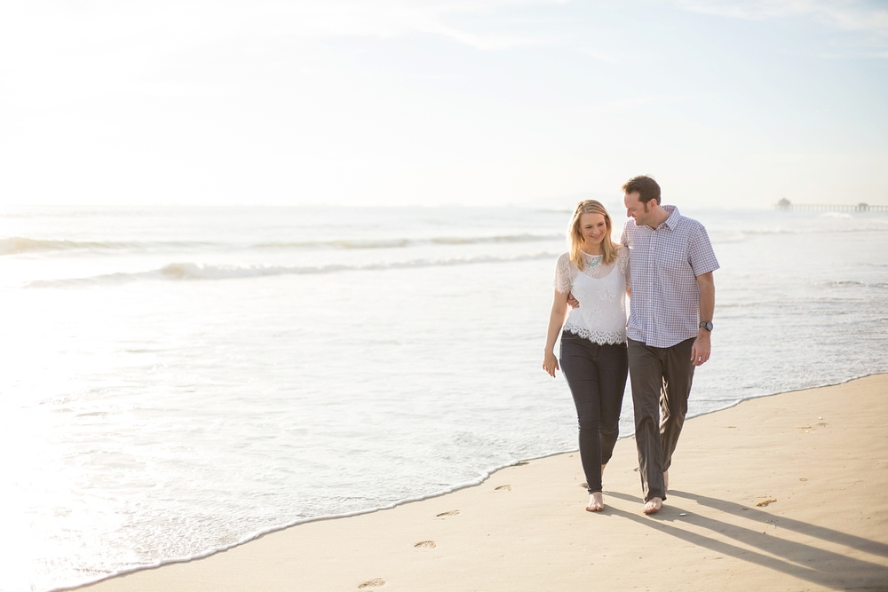 Engaged couple take a walk in Huntington Beach