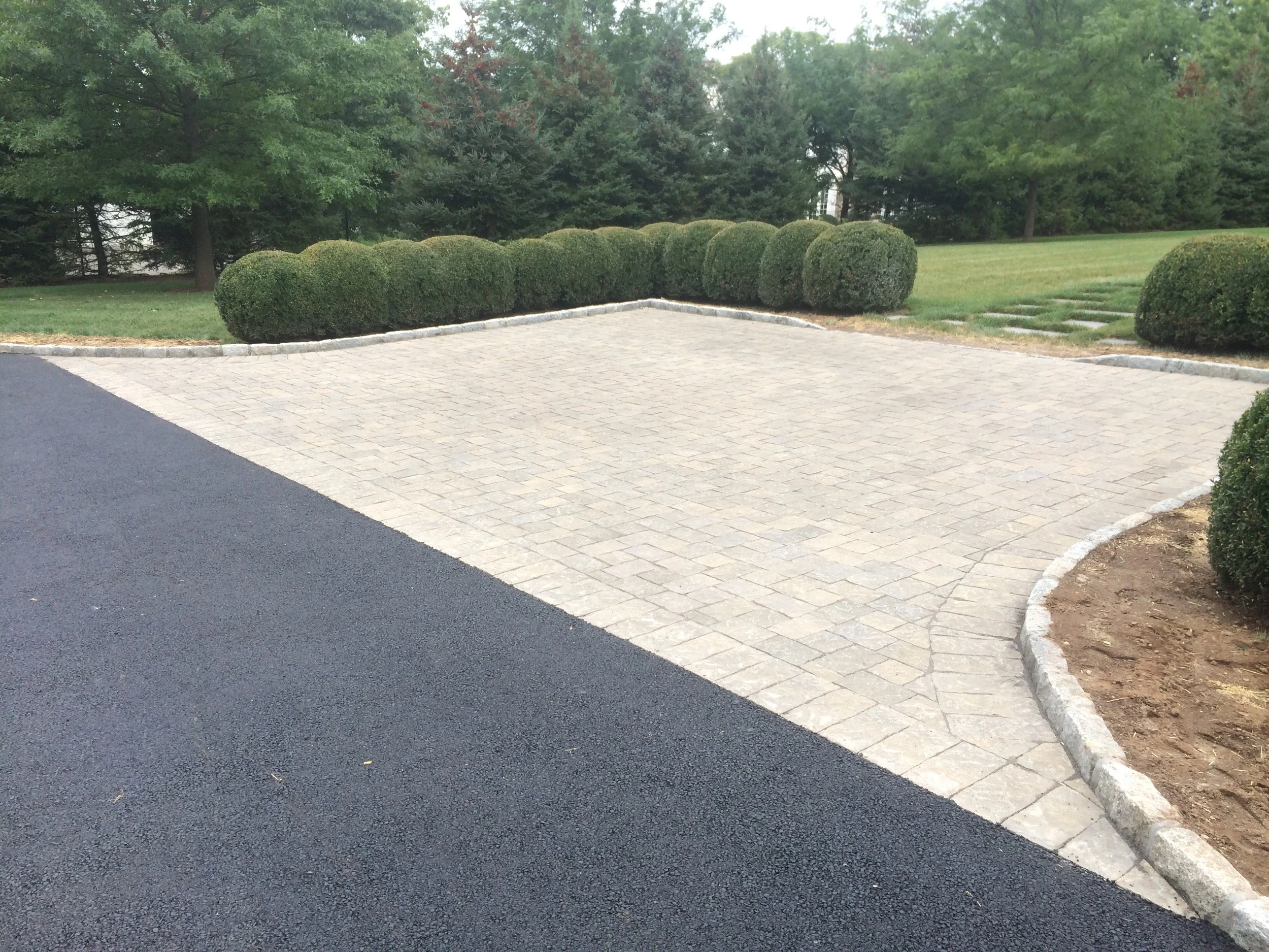 A driveway in Darien, CT with a parking area that has polymetric sand to prevent erosion. 