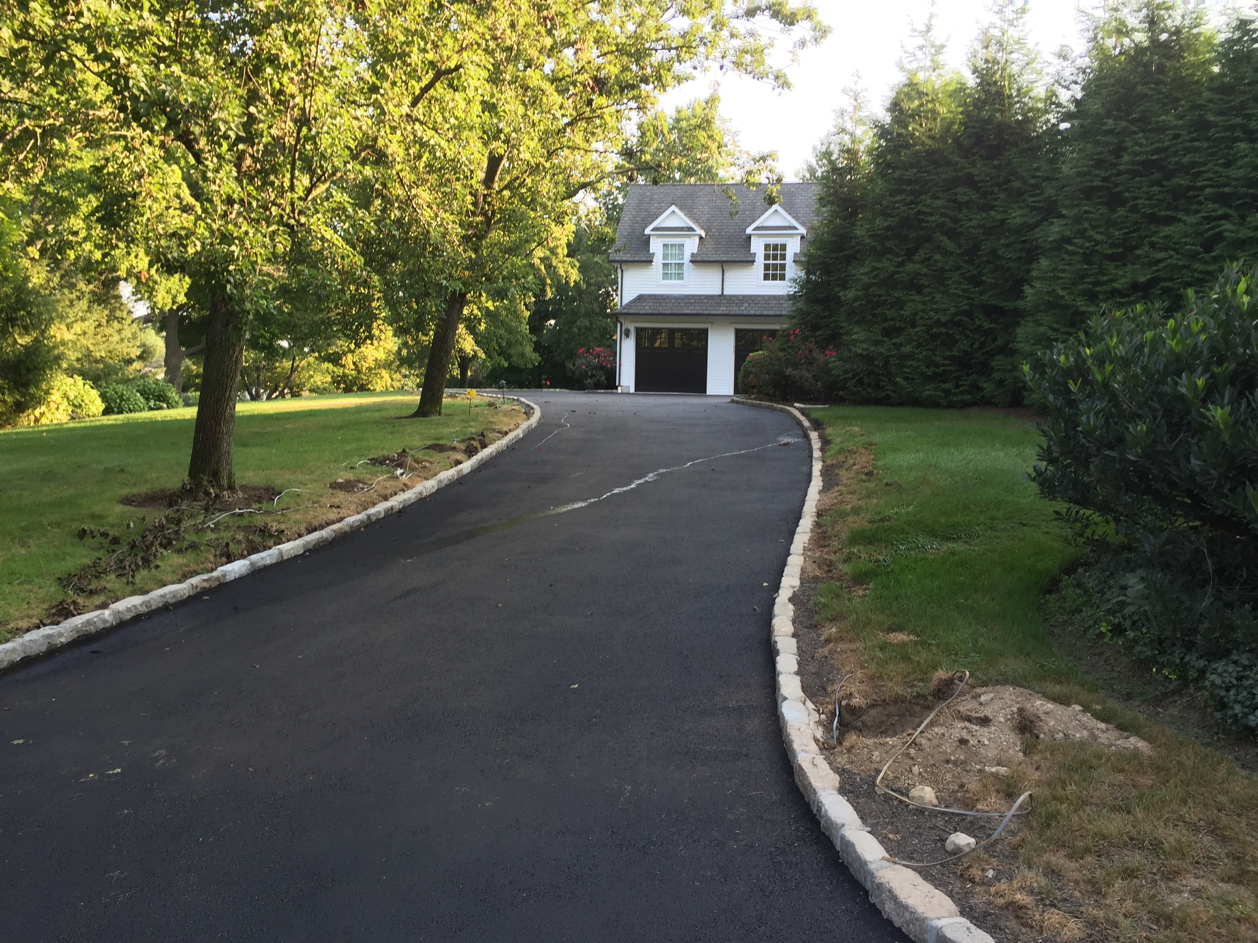 An asphalt driveway we did for a customer in Darien, CT. We also reset their existing Belgium block curbing