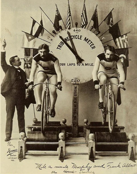 Famous speed bicyclist 'Mile-A-Minute' Murphy (left) and fellow cyclist Frank Albert race on a new stationary training machine. The Tribune Cycle Meter, decorated with international flags, measures the distance traveled. (Photo by Horner/Library of Congress/Corbis/VCG via Getty Images)