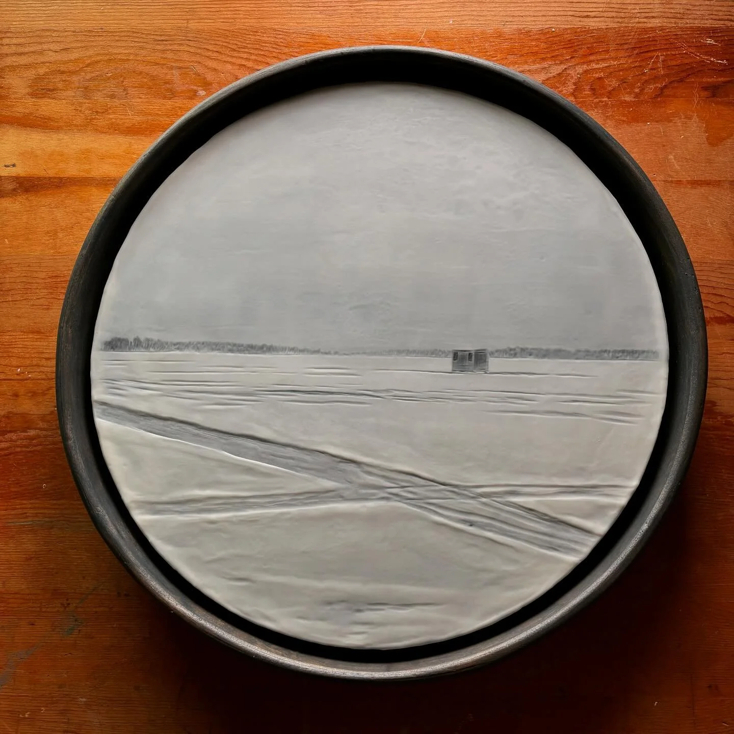 This encaustic photograph reflects the stillness of a winter day on a frozen lake in northern Minnesota. The solitary icehouse sits quietly in the distance, surrounded by tracks etched into the snow. 

#encaustic #photography #winterlandscape #icehou