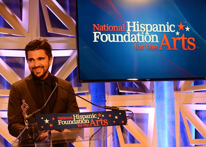 Juanes receiving the Raul Julia Award