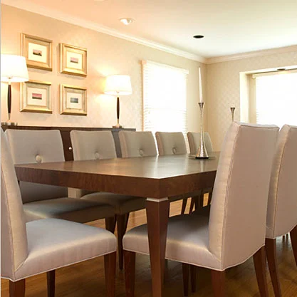 A formal dining room designed to accommodate twelve, which also needed to be family-friendly. Heavy duty upholstery that could be easily cleaned, but still look elegant, in a metallic finish and button detail complimented a custom-made table and con…