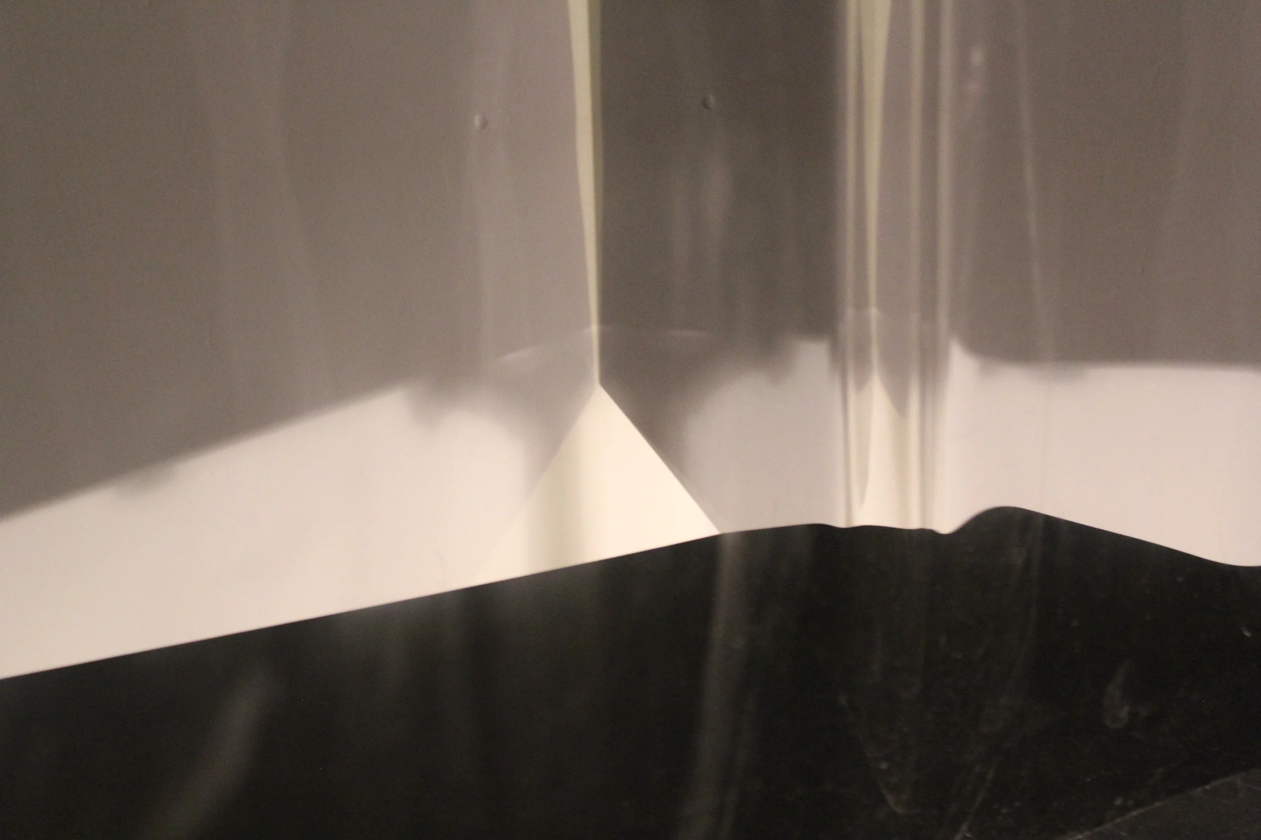This series is a study of light. The photographs are of the reflections and spaces between two surfaces creating these forms that appear to be physical objects within the photographs, but actually exist only as light. 13" x 17" Archival Prints