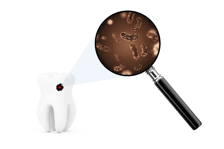 Bacteria On Tooth With Magnifying Glass.jpg