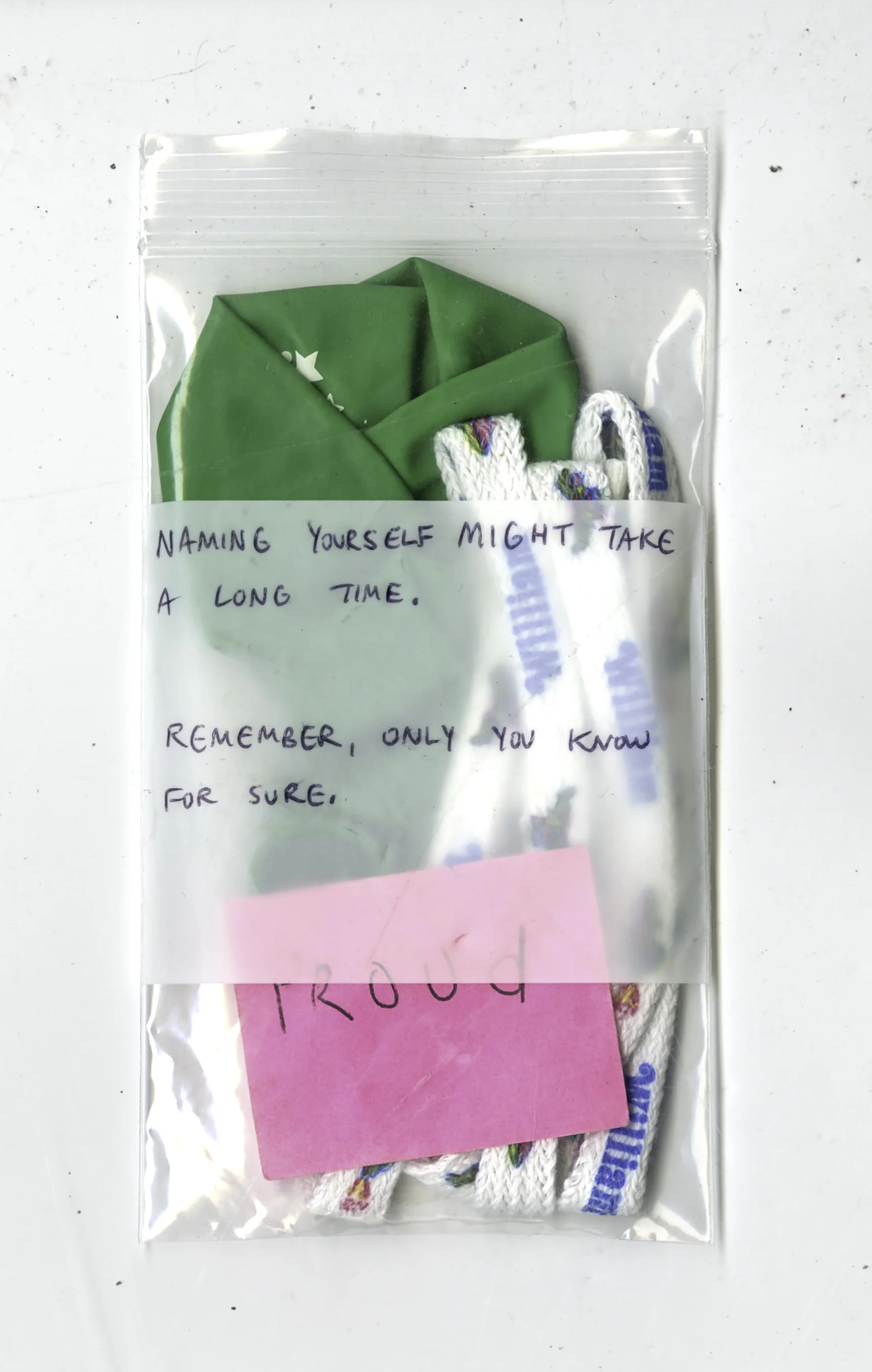 Naming yourself might take a long time. Remember, only you know for sure. , Noah balloon, William shoelaces, "proud" sticky note, Luan Bahn Mi receipt from Red Emma's cafe, bag, 2016