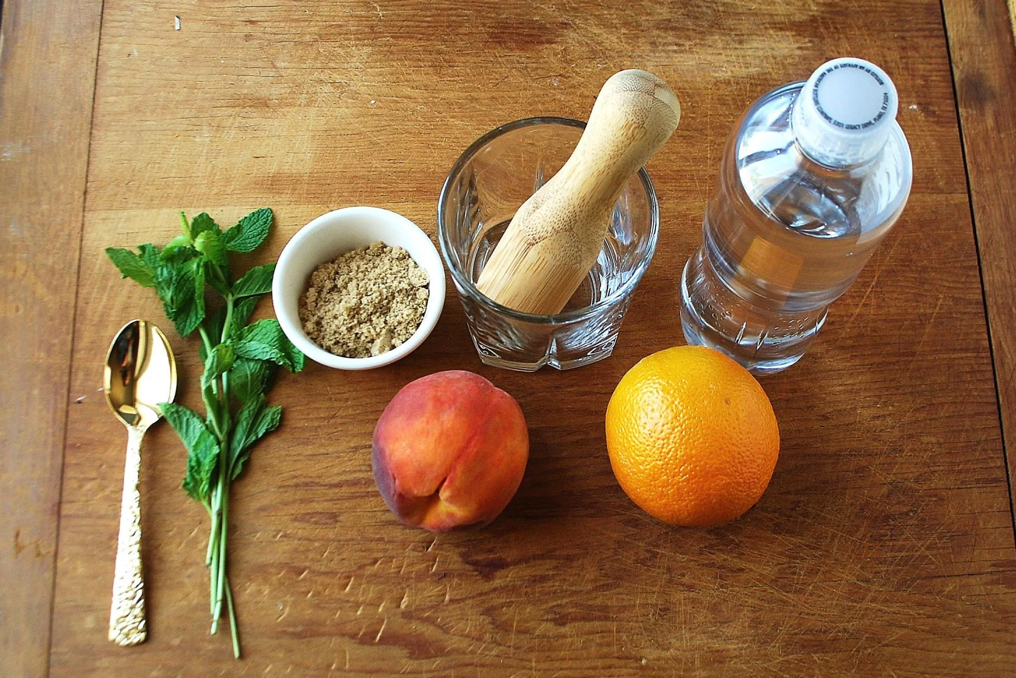 Place the brown sugar in the glass, then place 3-4 mint leaves in the glass with the sugar and gently muddle them with your muddler or other tool (I used a pestle). Stop when you start to smell the mint. Be sure not to tear or over smash the mint, doing so will make your drink bitter (Yuk!).