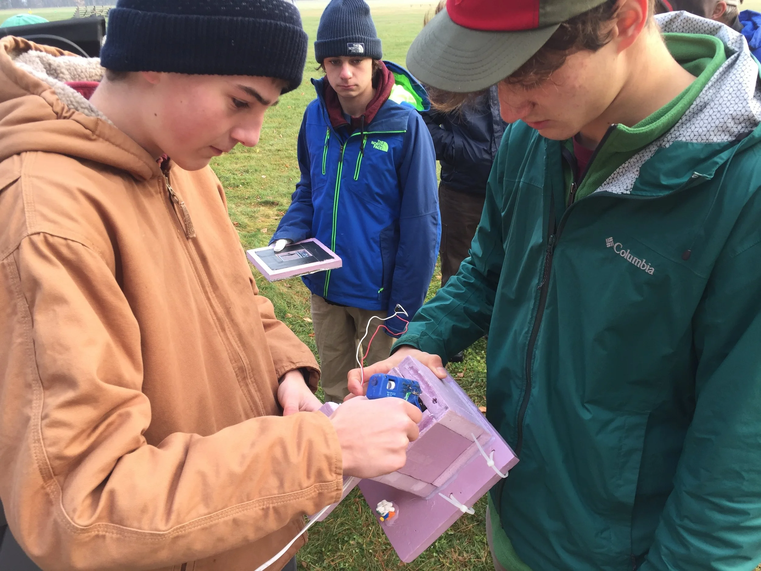  Glue guns and rigid foam insulation are a part of Profile's near space vehicle construction kit!  Here, the final touches are being applied to the mandatory back-up balloon release mechanism.  The primary balloon release occurs when the  balloon pops at its highest altitude . 