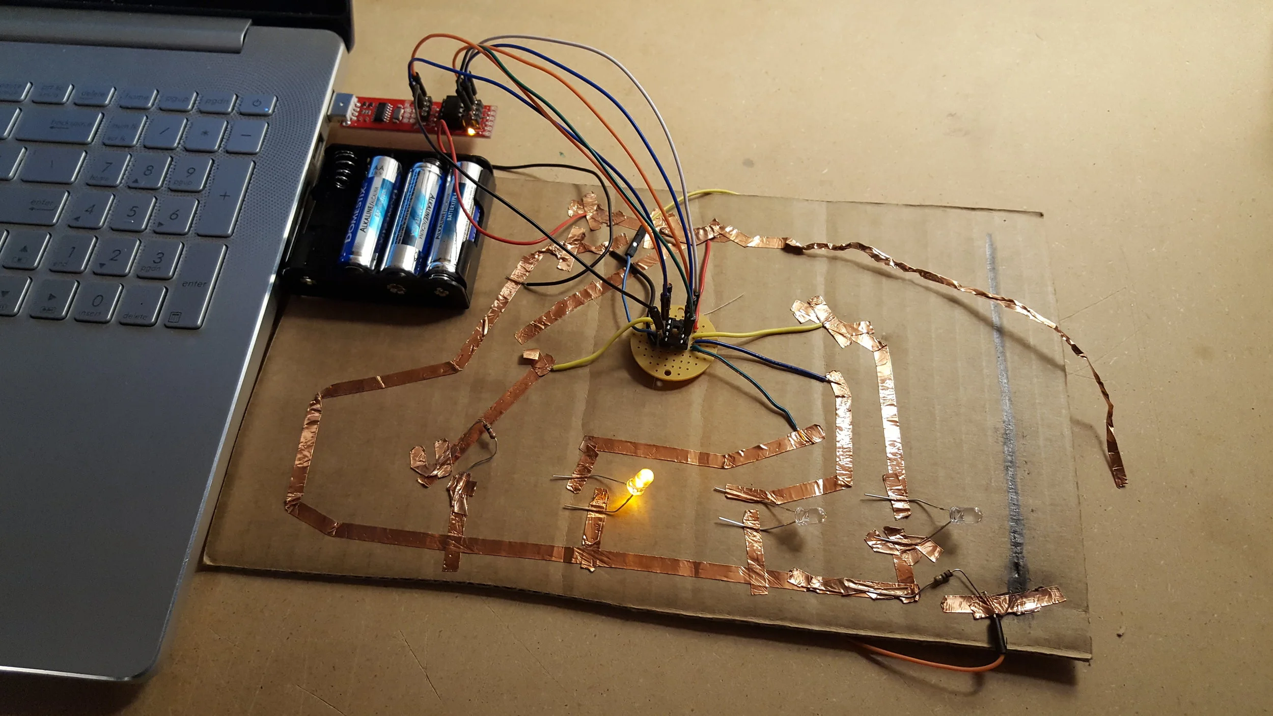   A circuit of blinking LEDs with the Spider’s ATtiny85 out of its socket to be reprogrammed  
