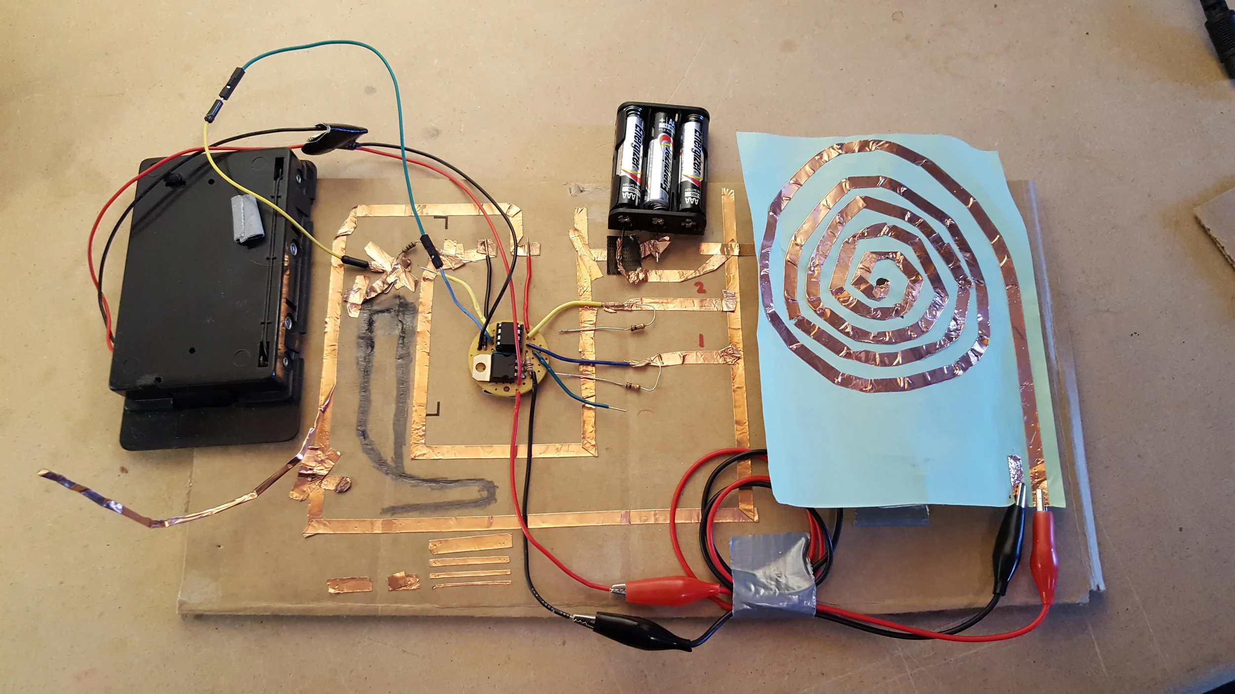 A fully-featured paper audio circuit, complete with plenty of batteries, a pencil resistor, paper speaker, and paper buttons.